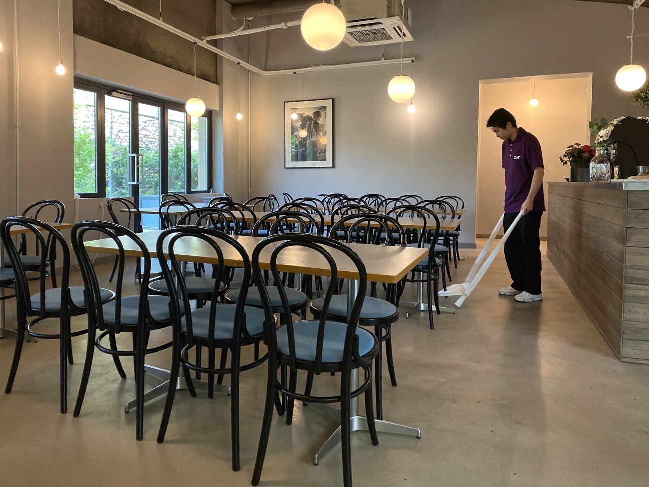 A FIXD team member finishing up in an empty café after closing